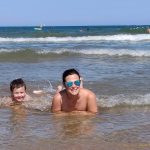 Two people enjoy the water at the beach