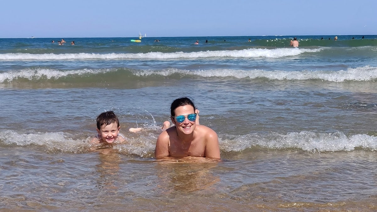 Two people enjoy the water at the beach